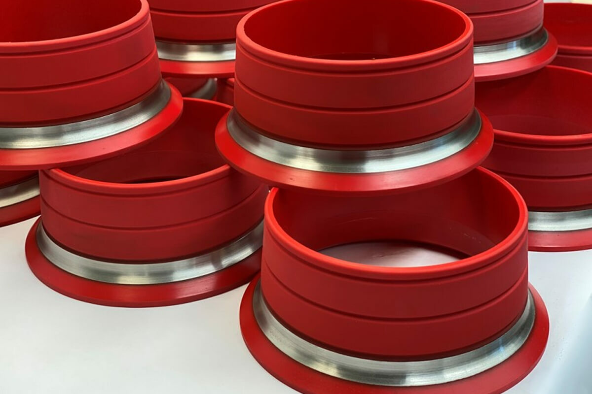 Cast polyurethane rollers with metal flanges showing high abrasion resistance and load-bearing strength