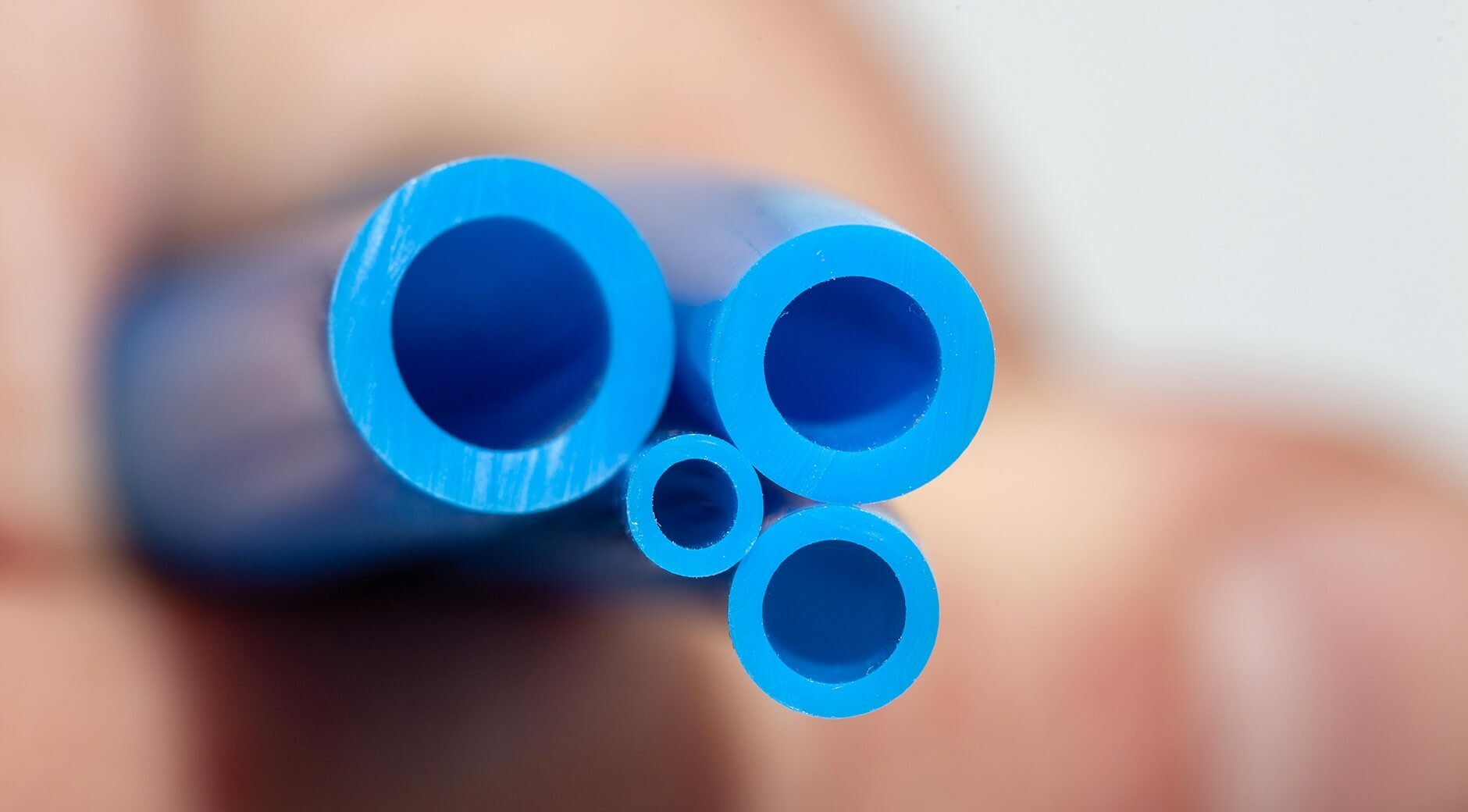 Close-up of blue polyurethane tubing cross-sections in various diameters